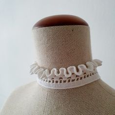 This white Neck Ruff crochet choker necklace is made from 100% high-quality mercerized white cotton and tied with a white pearl button.  Choker length 35 cm / 13,8 inches, width - 3 cm / 1,2 inches. A simple yet elegant accessory that will work well with a lot of looks. The choker is similar to the Elizabethan ruffled lace collar. Teenagers, who prefer clothes in the Gothic style, also like to wear them to emphasize their individuality. The choker can be used as an additional accent for creating costumes for Cosplay. When ordering, you can make a note of a custom neckline length if you would like. It can be made also in different colours, but keep in mind that this might push the date when the item is shipped out back by a few days. The colour in the picture might not be accurate due to di Elegant Handmade Summer Choker, White Adjustable Choker Necklace, Elegant White Choker For Summer, Spring Gift White Choker, Elegant White Summer Choker, Handmade White Choker For Spring, Elegant White Crochet Necklace, White Lace Choker Gift, Handmade White Necklaces For Spring