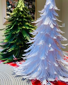 three paper christmas trees sitting on top of a table