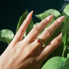 Strawberry Ring Adjustable Gold Ring Cute Jewelry Adorable Strawberry Ring Gift for Her Cottagecore Jewelry Fairy Ring Fairy Jewelry Gold __LISTING DESCRIPTION ☽ 18k Gold Plated Adjustable Ring, Enamel ☽ This ring is gold plated and may require extra care. PLEASE follow these tips to make the ring last longer in its original condition: avoid wearing it to the beach, pool, shower, bathtub, hot tub; avoid it touching any lotions, creams, or sweat; take it off before going to bed ☽ Packaged with a Cute Tiny Rings For Gifts, Cute Small Ring As Gift, Whimsical Adjustable Rings, Cute Flower Ring Gift, Cute Handmade Flower Ring For Gift, Fairycore Flower Shaped Jewelry Gift, Fairycore Flower Jewelry For Gifts, Handmade Cute Promise Ring, Cute Handmade Promise Ring