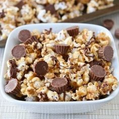 two white bowls filled with chocolate covered popcorn