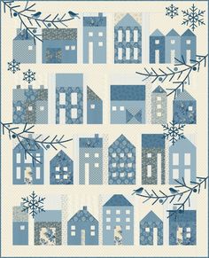 a blue quilt with houses and snowflakes on it