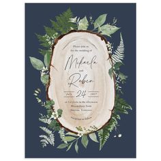 the rustic wood and greenery wedding card is shown in navy blue with white lettering