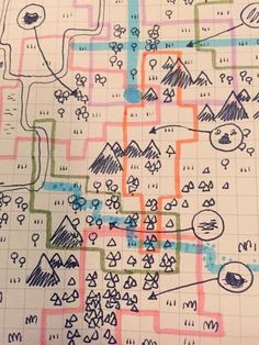 a map drawn on top of a piece of paper with different colored lines and shapes