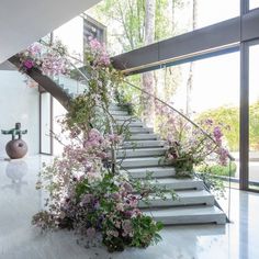 the stairs are covered with flowers and plants