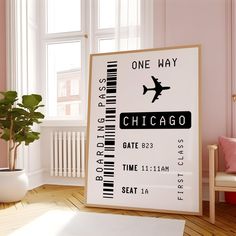 an airplane ticket poster hangs in the corner of a room with pink walls and wooden floors