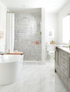 a bathroom with a tub, toilet and sink in it's center area is shown