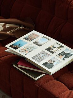 an open book sitting on top of a red couch