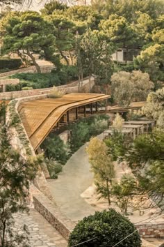 an aerial view of a wooden bridge in the woods