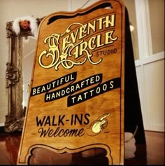 a wooden sign that says, beautiful handcrafted tattoo's walk - ins welcome