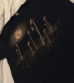 a group of mushrooms on a black shirt