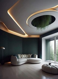 a modern living room with green walls and white furniture in the center is lit by recessed lights