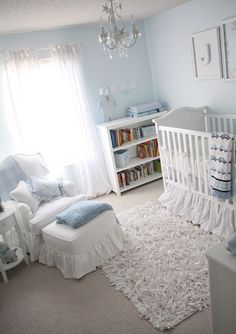 a baby's room is decorated in blue and white