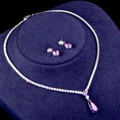 A beautiful two-piece bridal jewelry set with an incredible sparkle! Adorned with intricately faceted purple and clear cubic zirconia that capture the light from every angle with a perfectly translucent appeal, the pieces are platinum plated for a flawless finish which enhances the intricate detailing and conveys a modern take on old elegance. Necklace: 16.5" (approx. 42cm) long with a secure fold-over closure; pendant is 1" (approx. 2.5cm) long. If longer is needed please leave a note at checko Purple Diamond Jewelry, Purple Diamond Necklace For Wedding, Purple Diamond Wedding Necklace, Purple Diamond Necklaces For Wedding, Purple Crystal Jewelry Sets For Wedding, Dazzling Purple Jewelry With Diamond Accents, Elegant Purple Cubic Zirconia Jewelry, Purple Cubic Zirconia Jewelry Sets For Gift, Purple Cubic Zirconia Jewelry Sets As Gift