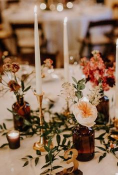 the table is set with candles and flowers