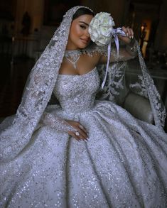 a woman in a white wedding gown and veil