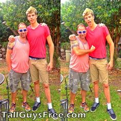 three men in pink shirts and khaki shorts posing for a photo