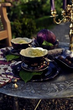 a table with plates and candles on it