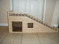 a dog house built into the floor with stairs