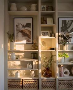 a shelf filled with lots of vases and pictures on top of it's shelves