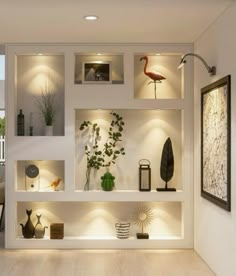 a living room filled with lots of furniture and lighting on top of white shelving