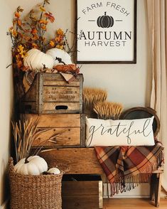 a wooden crate filled with pumpkins and other fall decorations