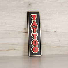 a black and red sign that says tattoo on it