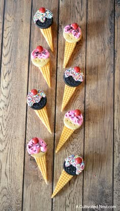 five ice cream cones with sprinkles on them