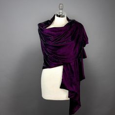 a mannequin wearing a purple dress with black trims and an asymmetric draped over it