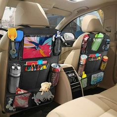 the back seat of a car with various items in it and an organizer hanging on the side