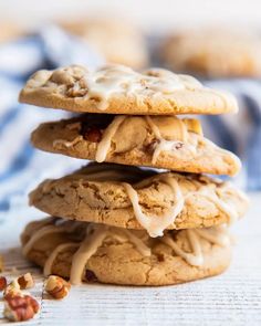 three cookies stacked on top of each other with icing drizzled over them