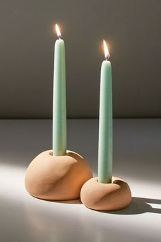 two candles sitting on top of each other