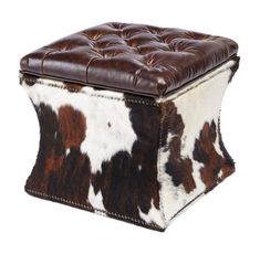 a brown and white cow hide ottoman