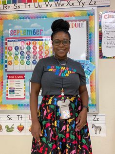 a woman standing in front of a bulletin board