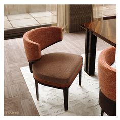 an orange chair sitting on top of a white rug next to a wooden dining table