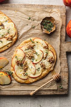 an apple and walnut pizza on a cutting board