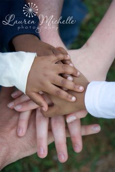 several hands stacked on top of each other