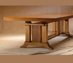 a wooden table sitting on top of a white sheet