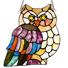 a stained glass owl hanging from a chain