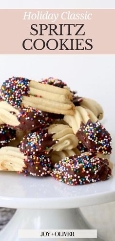 holiday classic spritz cookies on a white plate with chocolate and sprinkles