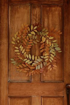 a wooden door with a wreath on it