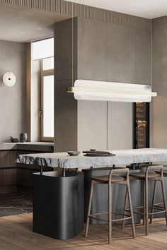 a modern kitchen with marble counter tops and bar stools