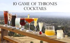 there are many drinks lined up on the balcony railing with text overlay that says, 10 game of throne cocktails