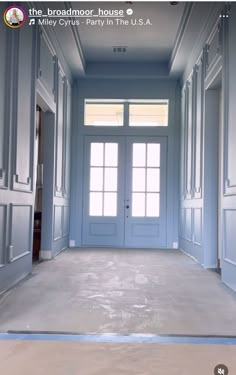 an empty room with blue doors and windows