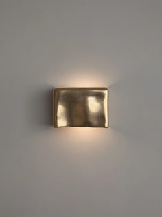 a close up of a wall light on a white wall with no lighting in it