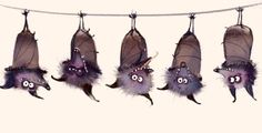 several bats hanging from a line with eyes and ears on them, all decorated in purple feathers