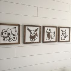 three framed pictures on the wall with different animals drawn on them in black and white