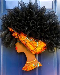 a woman's head is adorned with black curly hair and an orange dress on the front door