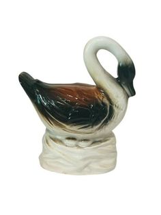 a white and black swan figurine sitting on top of a table