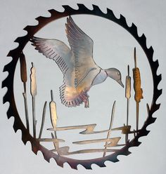 a metal clock with a bird flying through the air and forks in front of it