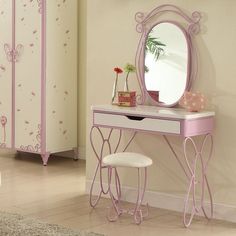 a pink dressing table with mirror and stool in a girls'bedroom or playroom